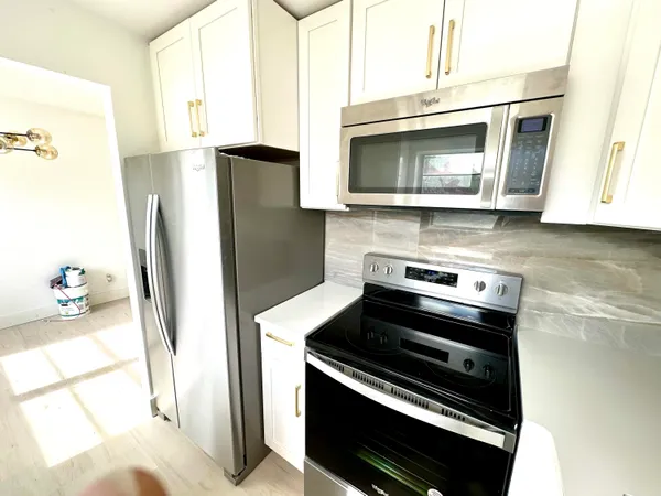 a kitchen with a stove and a microwave