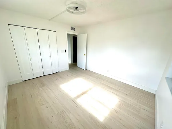 a view of an empty room and wooden floor