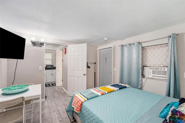 a bedroom with a bed and a flat screen tv