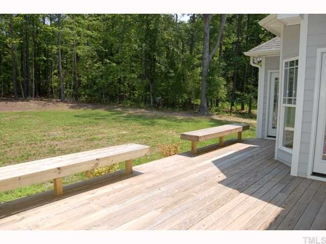 6912 Johnson Mill Road Bahama, NC 27503 - Photo 10 of 12 Deck overlooks the private back which includes both a level, grassy area, and a wooded backdrop. Property extends well beyond the tree line.