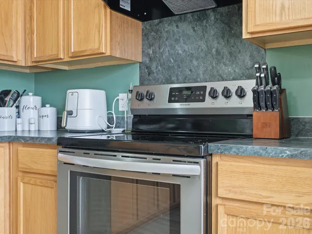 a stove top oven sitting inside of a kitchen