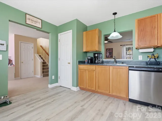 a kitchen with a sink cabinets and wooden floor