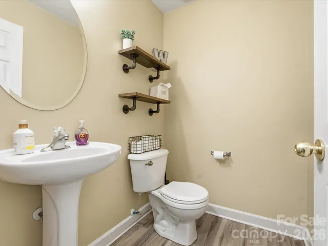 a bathroom with a sink mirror and toilet