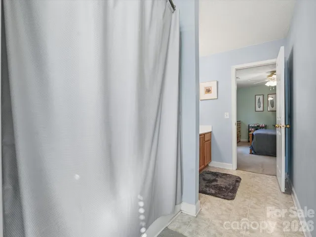 a bathroom with a shower and a bath tub