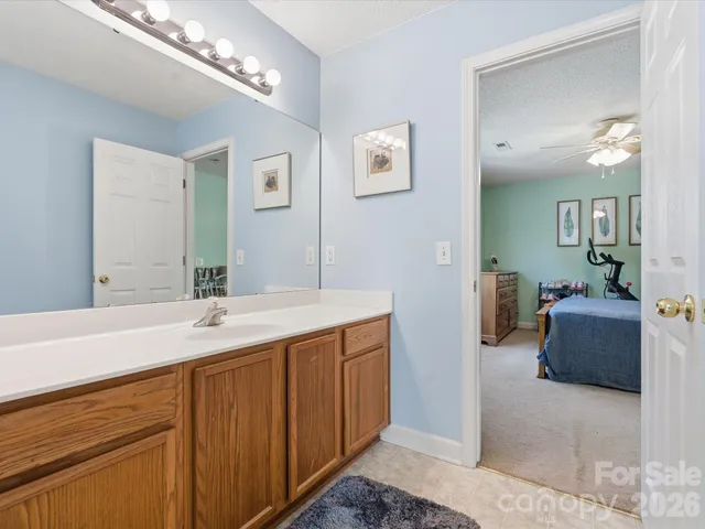 a spacious bathroom with a granite countertop sink a mirror and a