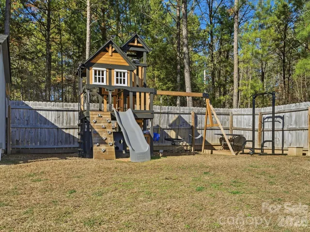 a view of a wooden deck with a backyard