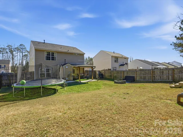 a view of a house with a yard and sitting area