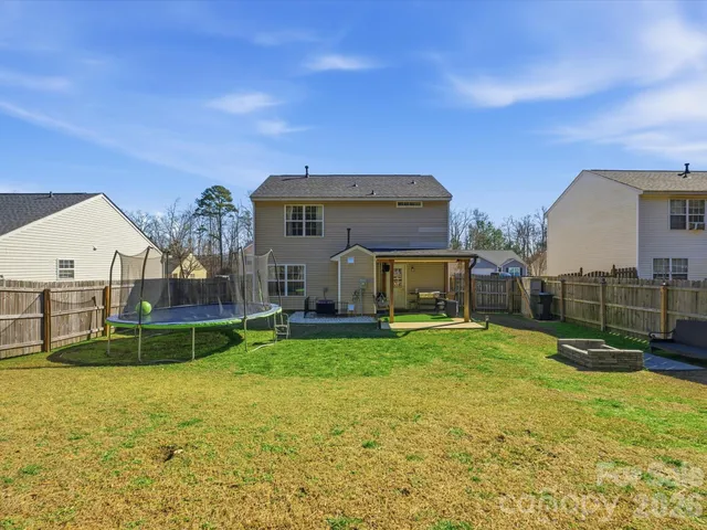 a view of a house with a yard and sitting area