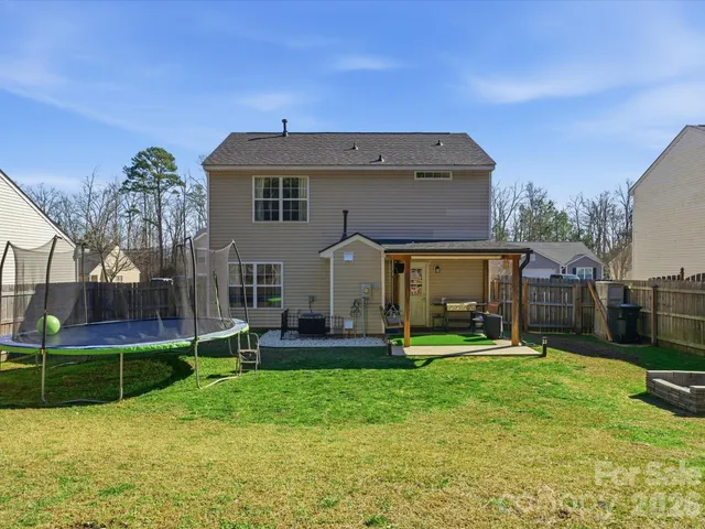 a view of a house with a yard and sitting area