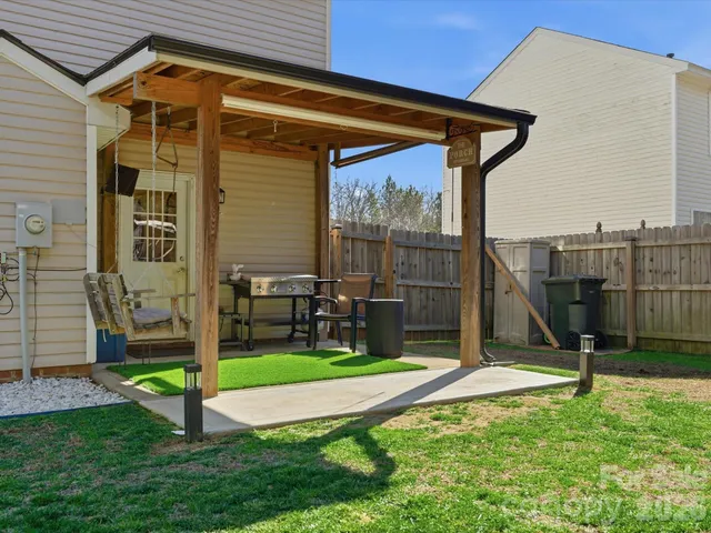 a view of a chair and table in front of a house