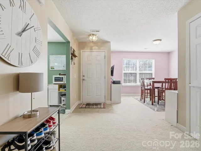 a living room with furniture a flat screen tv and a table