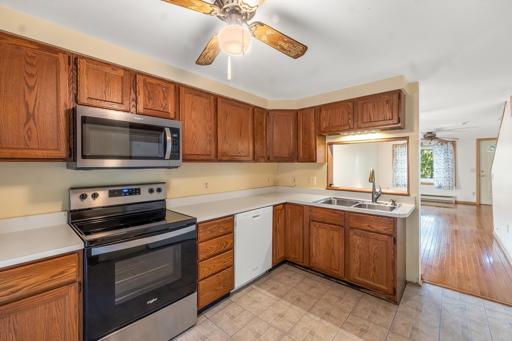 29 A Chilmark Street Worcester, MA 01604 - Photo 8 of 25 a kitchen with stainless steel appliances a stove sink microwave and cabinets