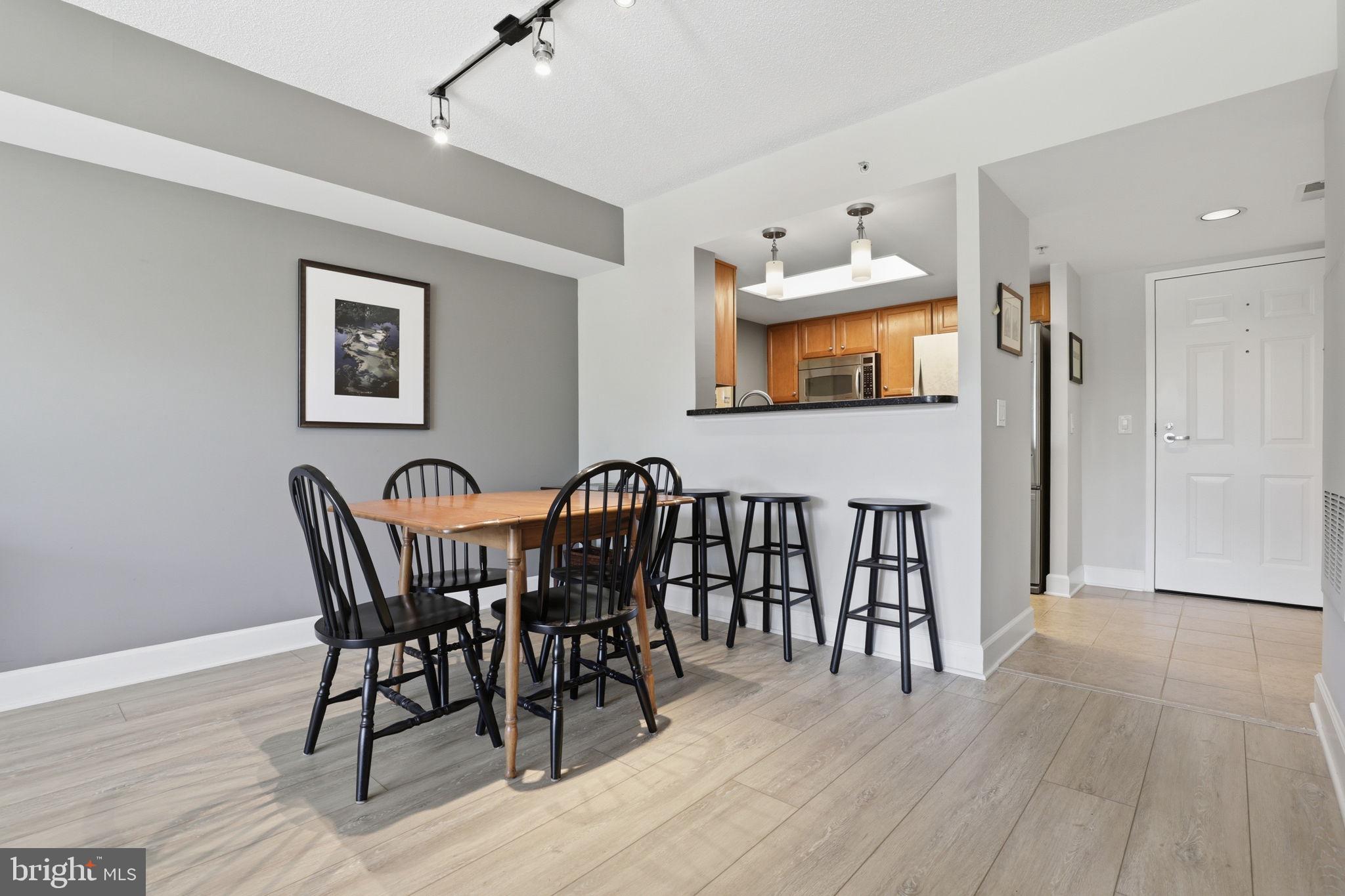 11800 Sunset Hills Road, Unit 218 Reston, VA 20190 - Photo 28 of 38 a view of a dining room with furniture and wooden floor