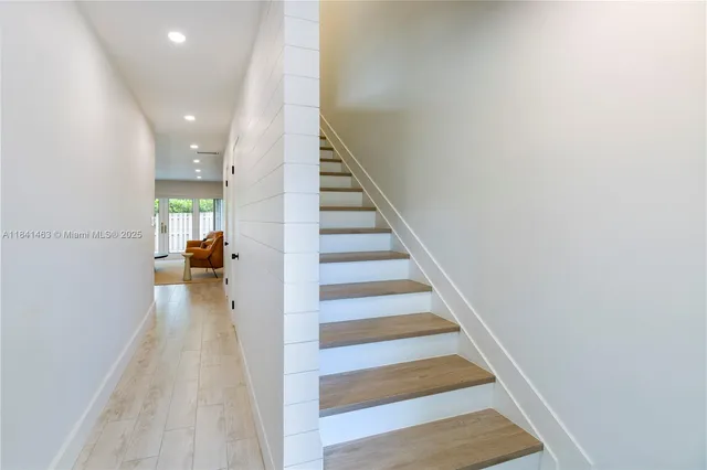 a view of entryway and hall with wooden floor