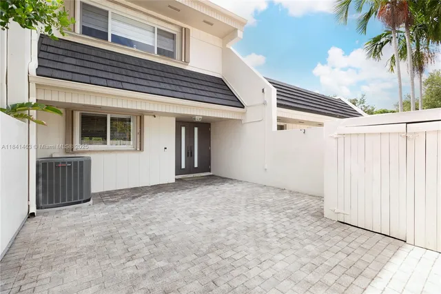 a view of a house with a backyard and entryway
