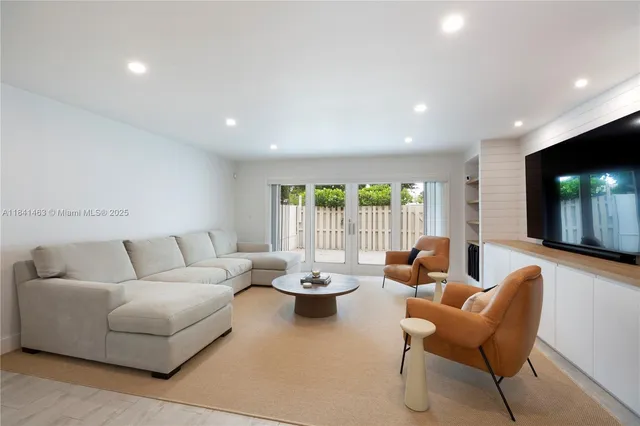 a living room with furniture and large window