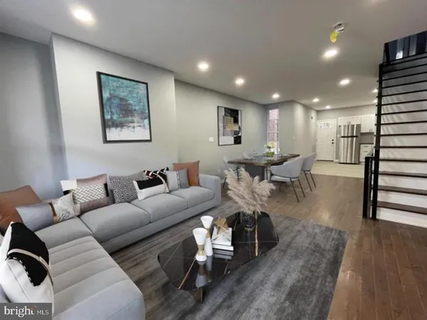 a living room with furniture and wooden floor