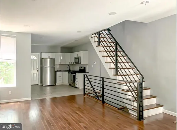 a view of kitchen with furniture and wooden floor