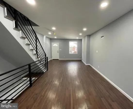 wooden floor in an empty room with stairs