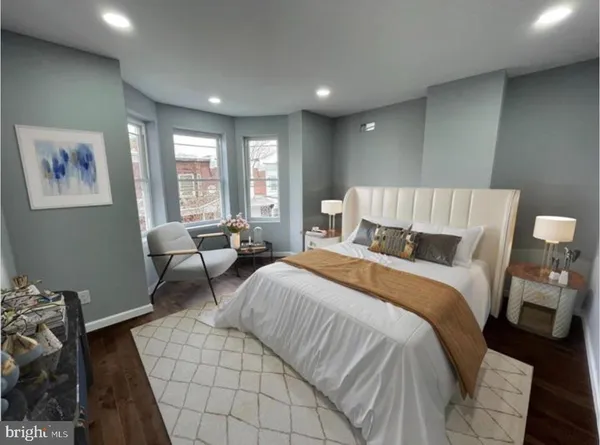 a spacious bedroom with a bed and a couch