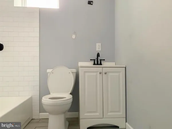 a bathroom with a toilet a sink and bathtub