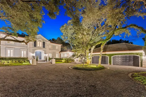 a view of a swimming pool with a garden and trees