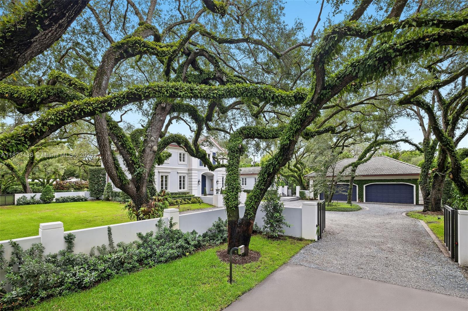 5400 Banyan Trail Coral Gables, FL 33156 - Photo 12 of 75 a front view of a house with garden and trees