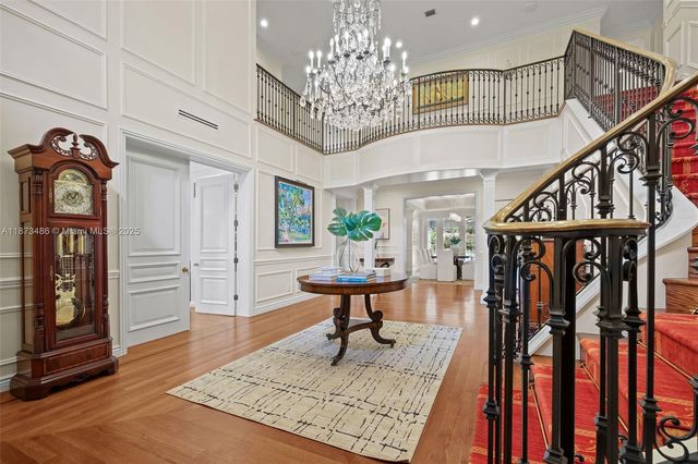 a living room with furniture and a dining table with wooden floor