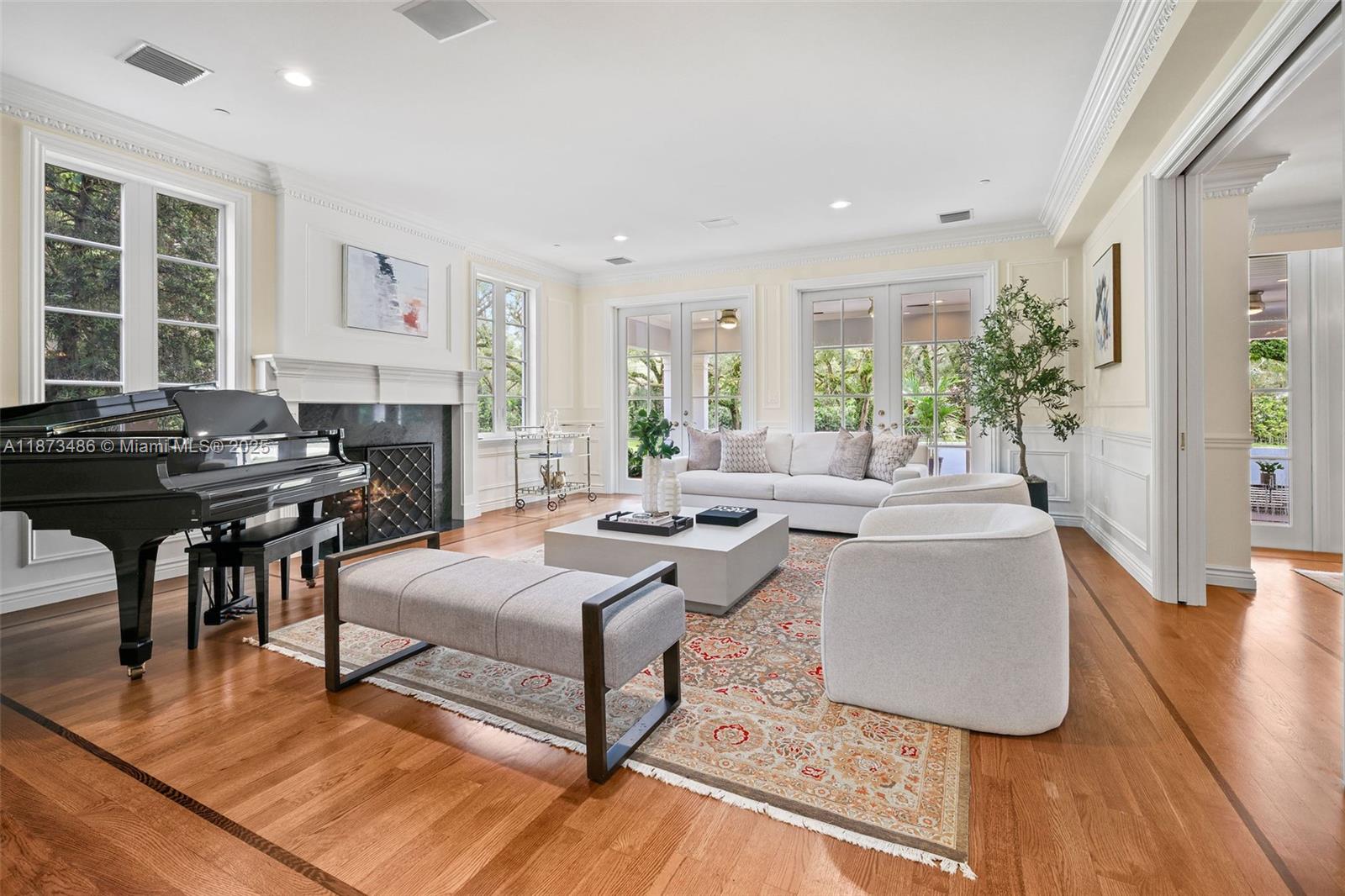 5400 Banyan Trail Coral Gables, FL 33156 - Photo 24 of 75 a living room with fireplace furniture and a large window