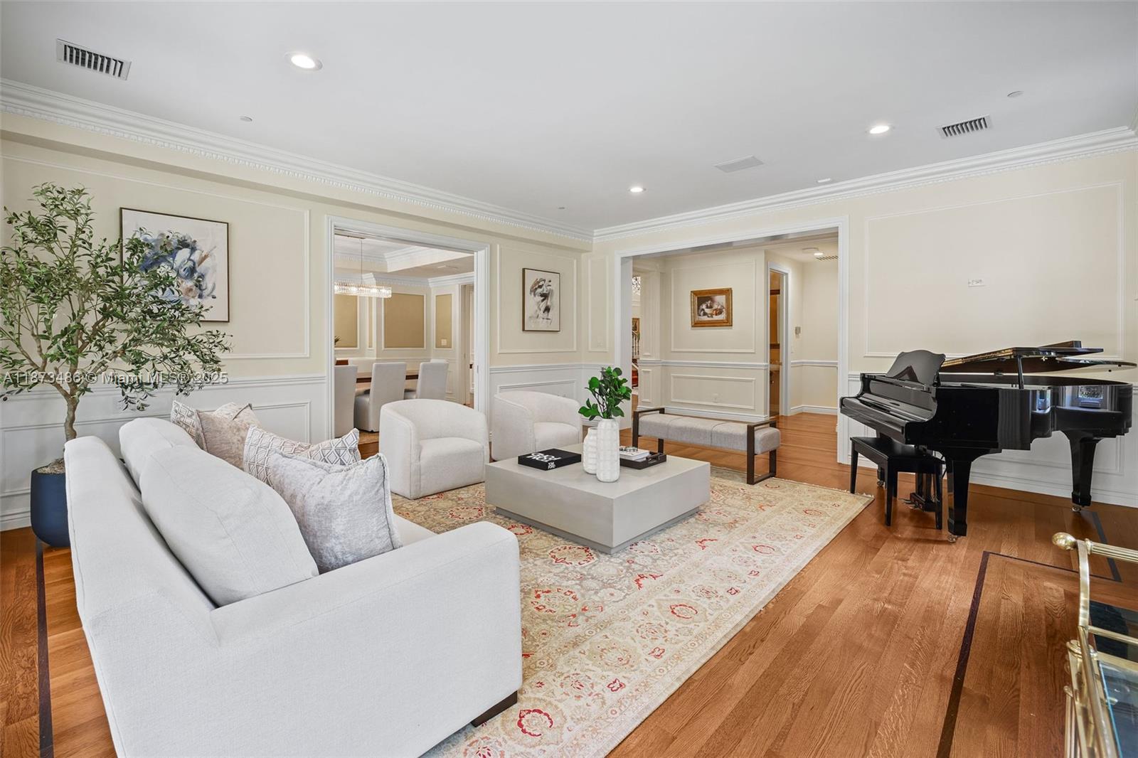 5400 Banyan Trail Coral Gables, FL 33156 - Photo 25 of 75 a living room with furniture and a dining table with wooden floor