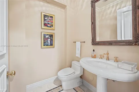 a view of a kitchen with white cabinets and wooden floor