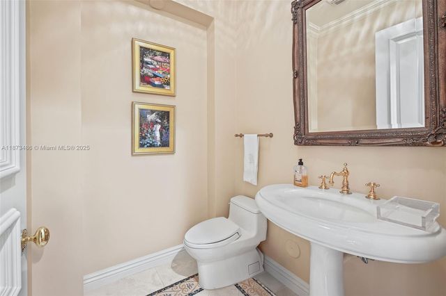 a view of a kitchen with white cabinets and wooden floor