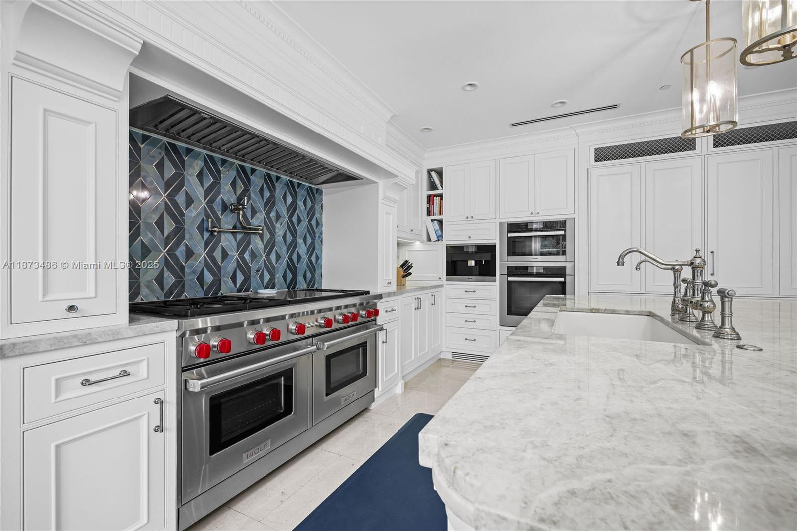 5400 Banyan Trail Coral Gables, FL 33156 - Photo 31 of 75 a kitchen with stainless steel appliances a stove and a refrigerator