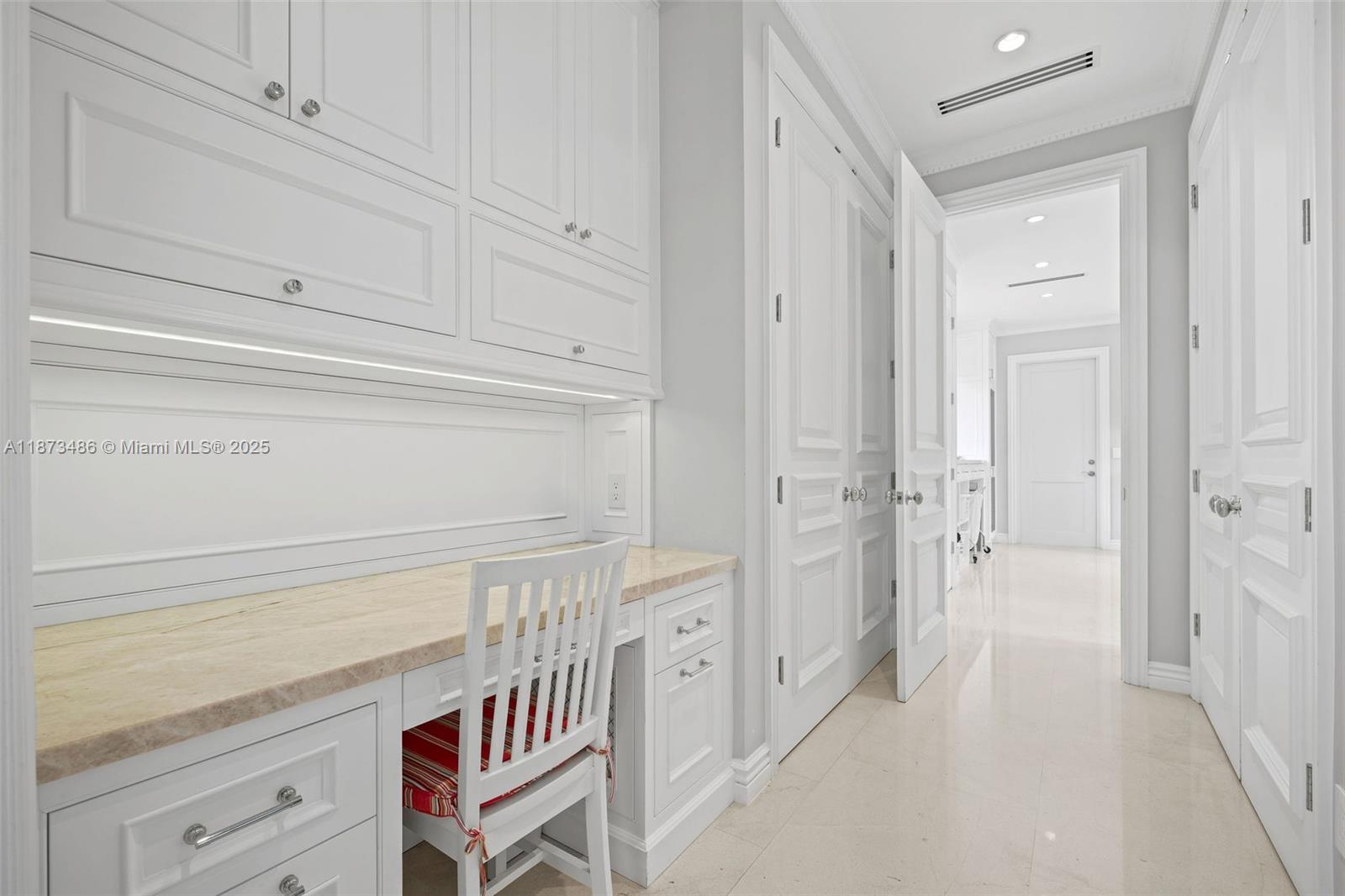 5400 Banyan Trail Coral Gables, FL 33156 - Photo 36 of 75 a view of a kitchen with white cabinets and wooden floor