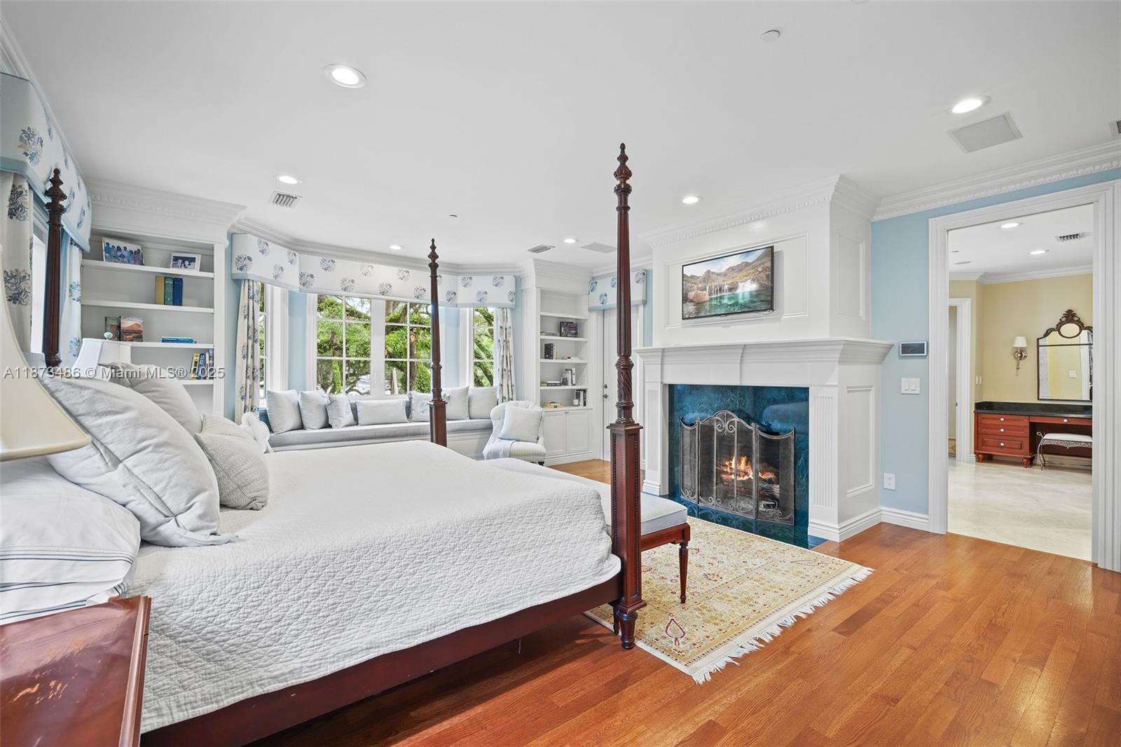 5400 Banyan Trail Coral Gables, FL 33156 - Photo 42 of 75 a bedroom with a bed and a fireplace