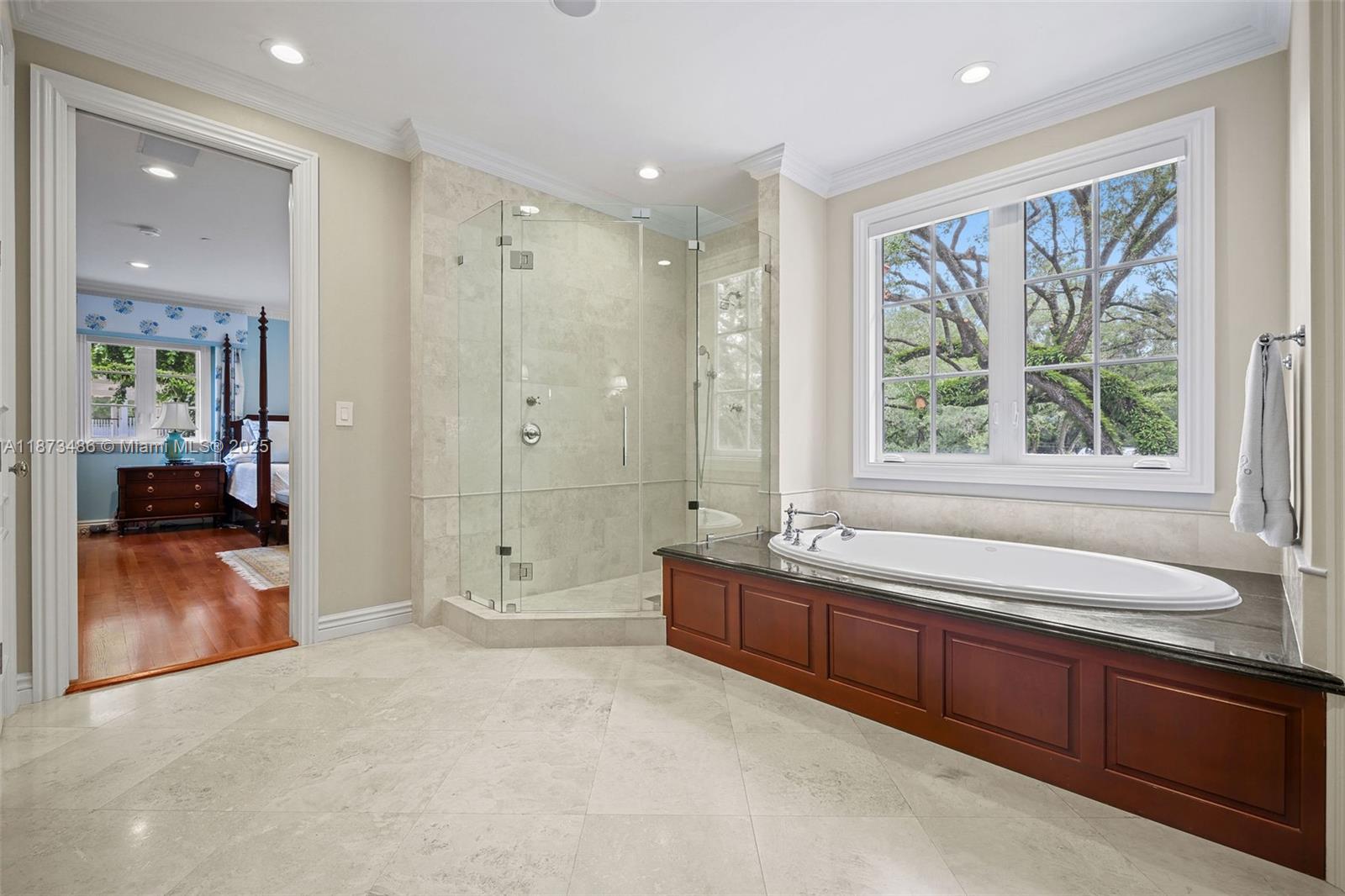 5400 Banyan Trail Coral Gables, FL 33156 - Photo 47 of 75 a spacious bathroom with a granite countertop tub sink shower and mirror