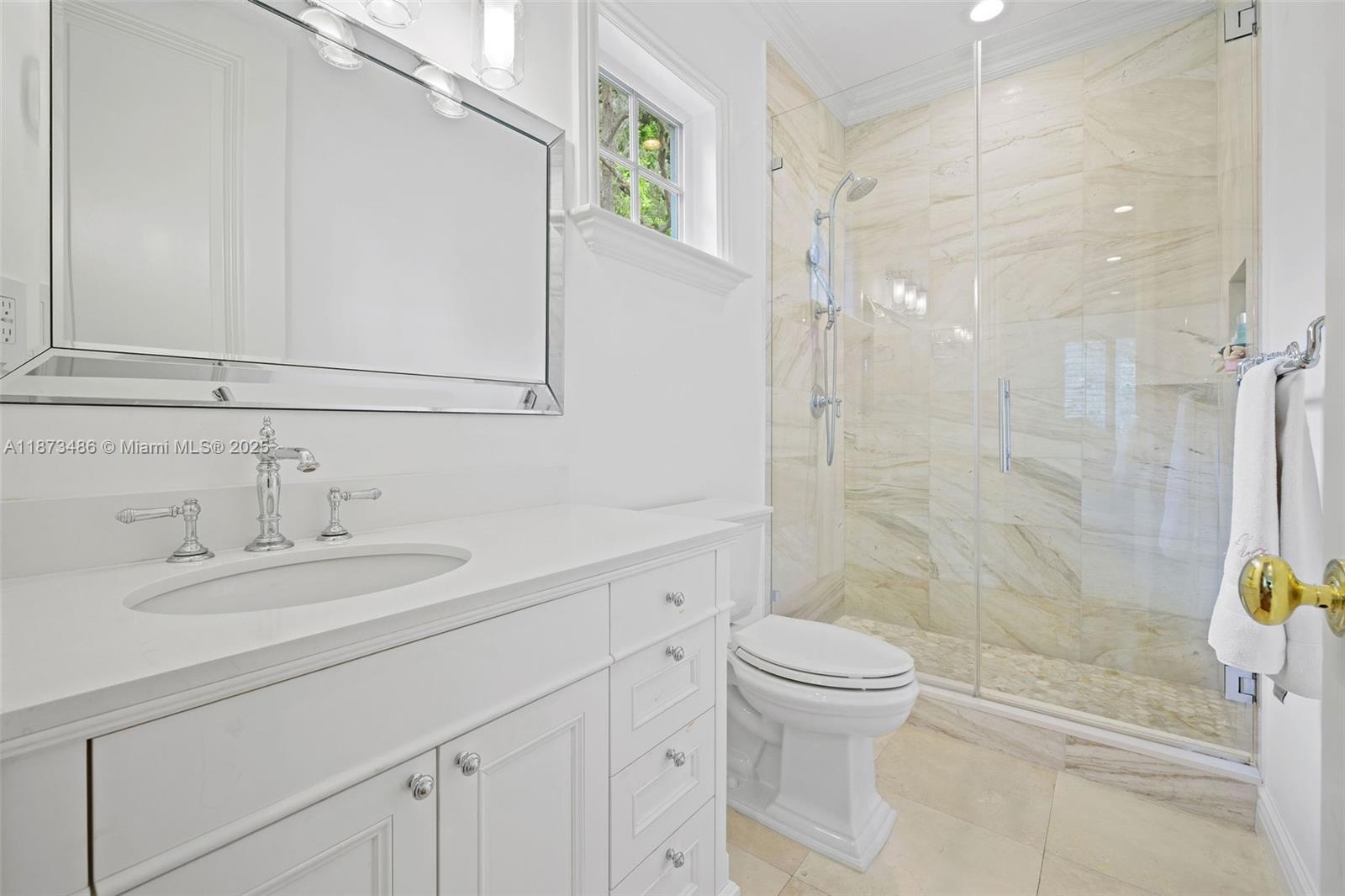 5400 Banyan Trail Coral Gables, FL 33156 - Photo 51 of 75 a bathroom with a sink a toilet and shower
