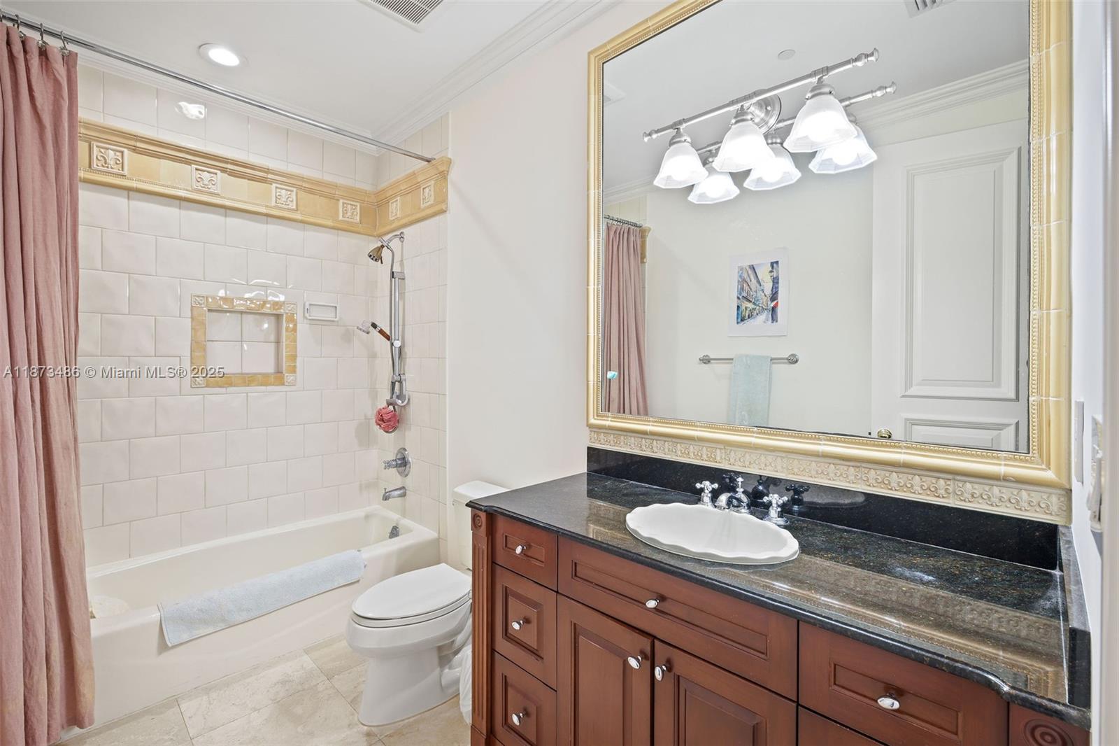 5400 Banyan Trail Coral Gables, FL 33156 - Photo 53 of 75 a bathroom with a granite countertop sink a toilet a mirror a bathtub and shower