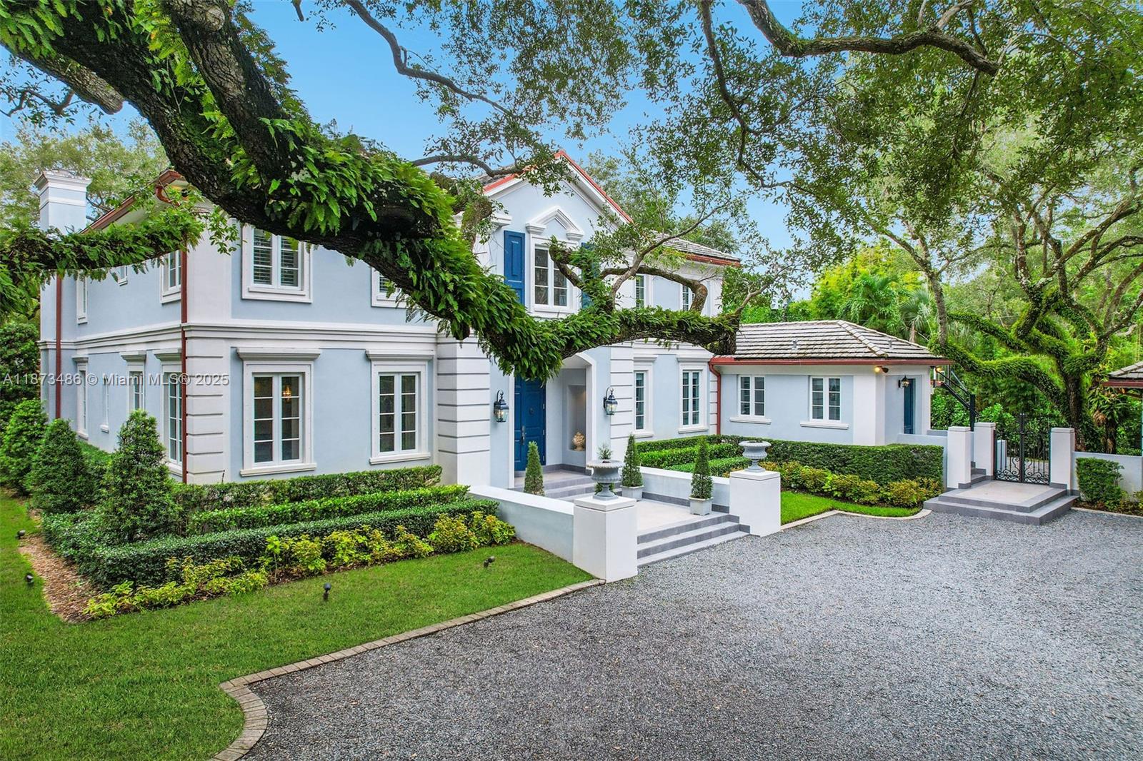 5400 Banyan Trail Coral Gables, FL 33156 - Photo 55 of 75 a front view of a house with garden
