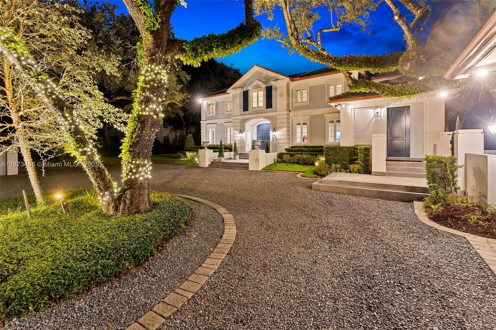 5400 Banyan Trail Coral Gables, FL 33156 - Photo 60 of 75 a front view of a house with a yard