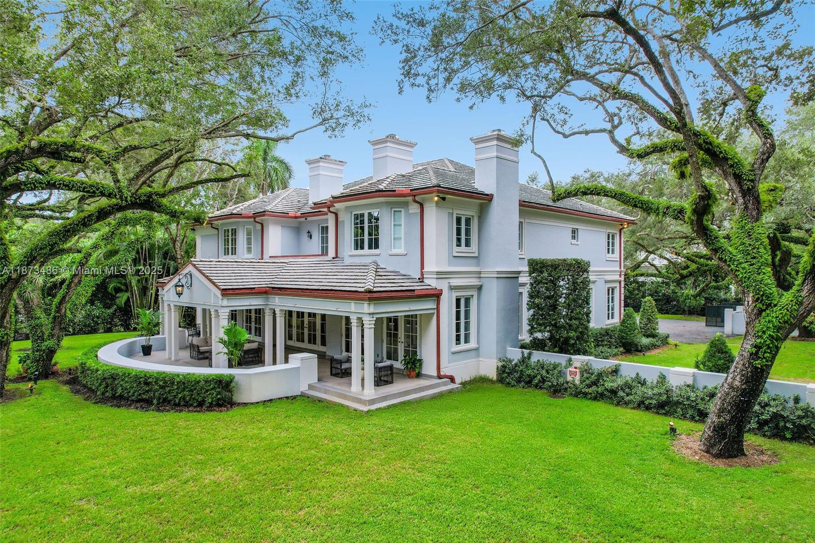 5400 Banyan Trail Coral Gables, FL 33156 - Photo 6 of 75 a front view of a house with a garden