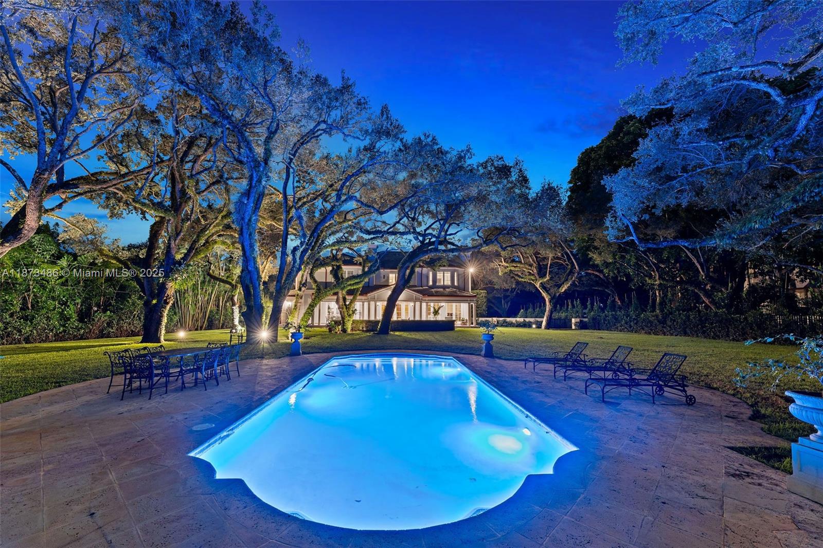 5400 Banyan Trail Coral Gables, FL 33156 - Photo 68 of 75 a view of a swimming pool with a patio and a yard