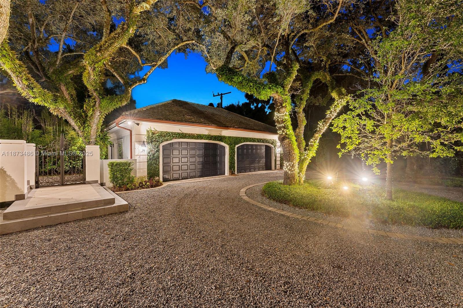 5400 Banyan Trail Coral Gables, FL 33156 - Photo 73 of 75 a front view of a house with yard and garage