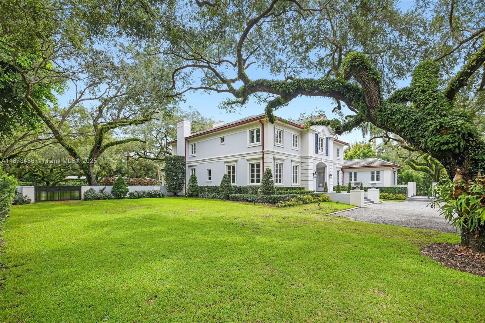5400 Banyan Trail Coral Gables, FL 33156 - Photo 9 of 75 a view of a house with a big yard and large trees