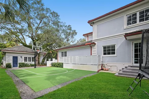 a dining room with wooden floor and furniture