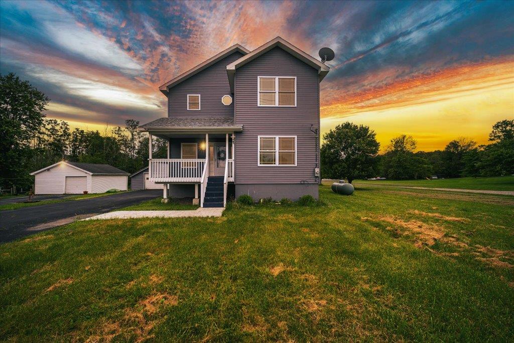 2017 Mt Hope Road Middletown, NY 10940 - Photo 1 of 1 Traditional-style house featuring a porch, a front lawn, and a garage