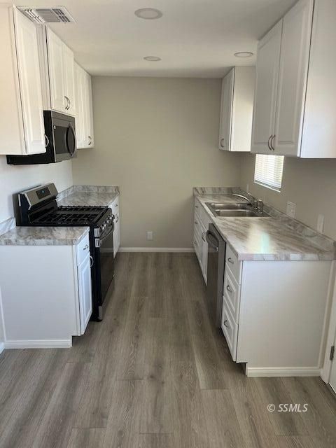 436 North Warner Street Ridgecrest, CA 93555 - Photo 3 of 30 a kitchen with a sink stove top oven and cabinets