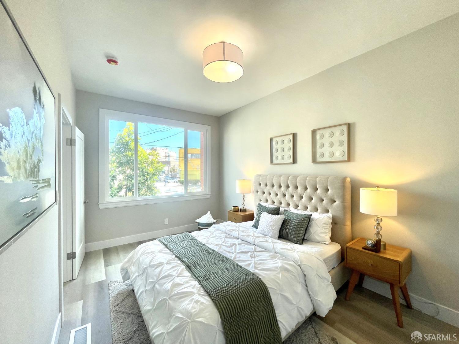 37 Ruth Street San Francisco, CA 94112 - Photo 11 of 26 a bedroom with a bed and a lamp next to a window