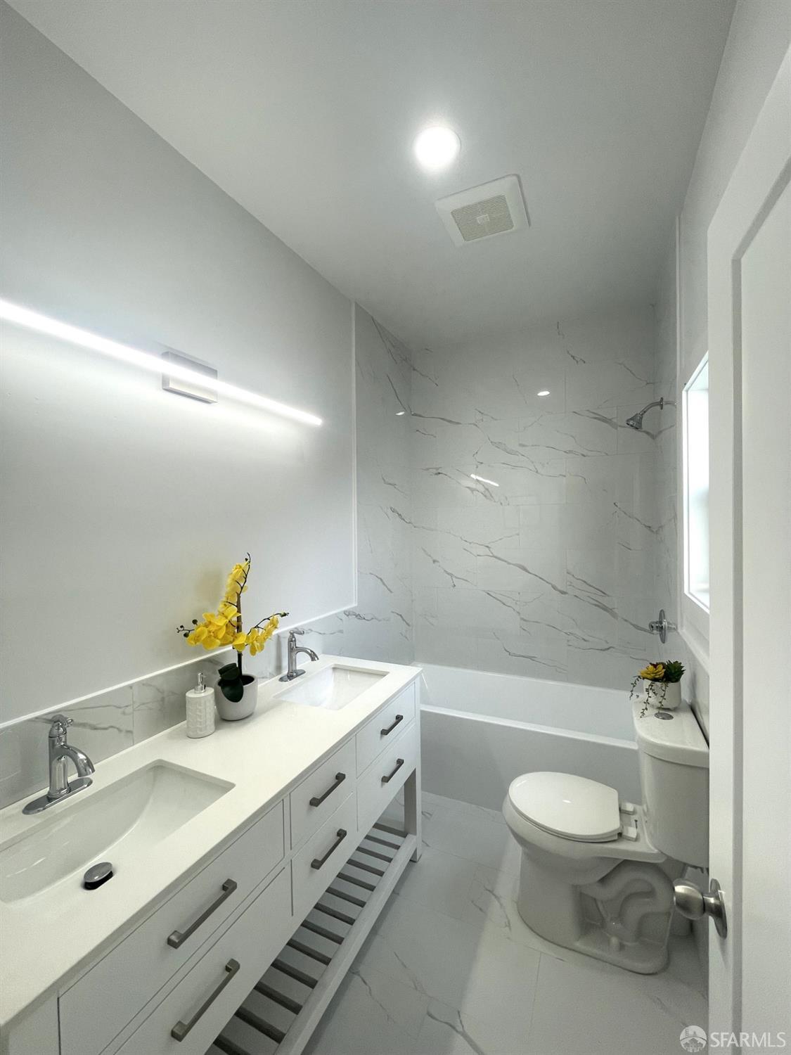 37 Ruth Street San Francisco, CA 94112 - Photo 16 of 26 a bathroom with a double vanity sink toilet and a bathtub