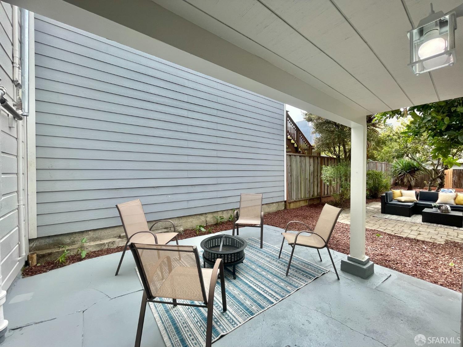 37 Ruth Street San Francisco, CA 94112 - Photo 20 of 26 a view of a patio with table and chairs and floor to ceiling window